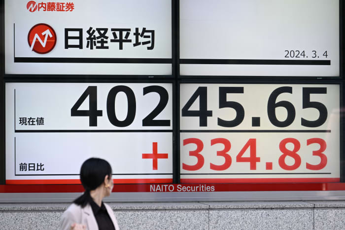 Japan's benchmark Nikkei 225 tops 40,000 for first time, lifted by