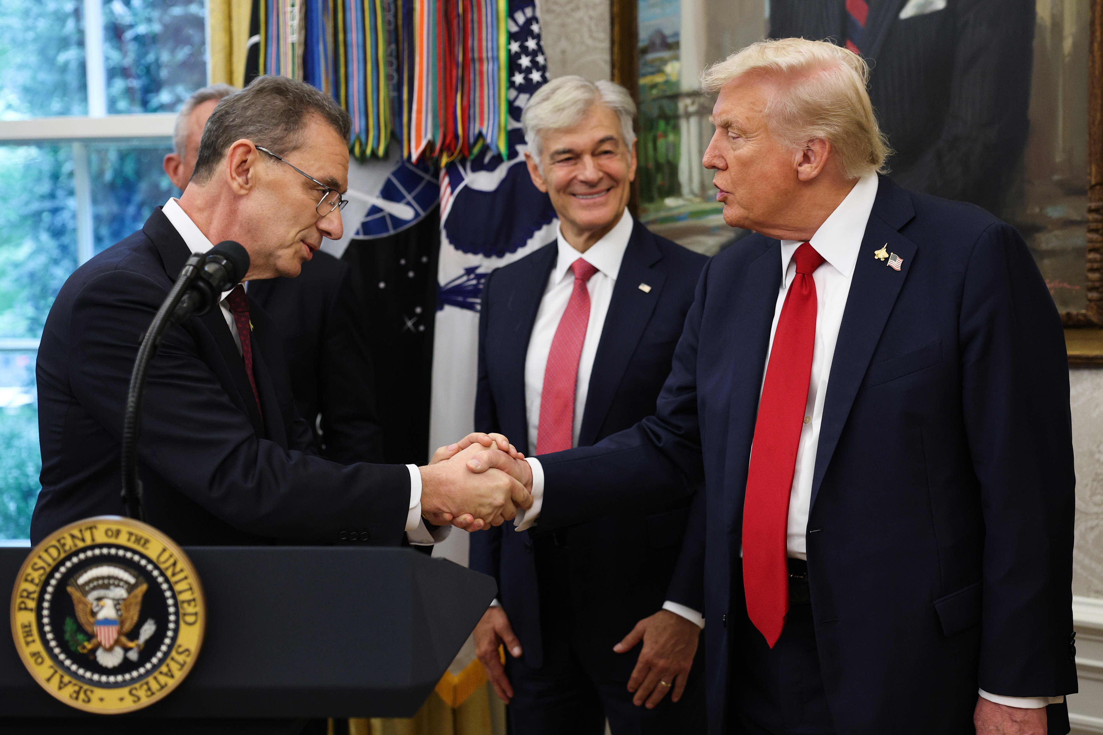 Pfizer CEO Albert Bourla shaking hands with President Donald Trump.