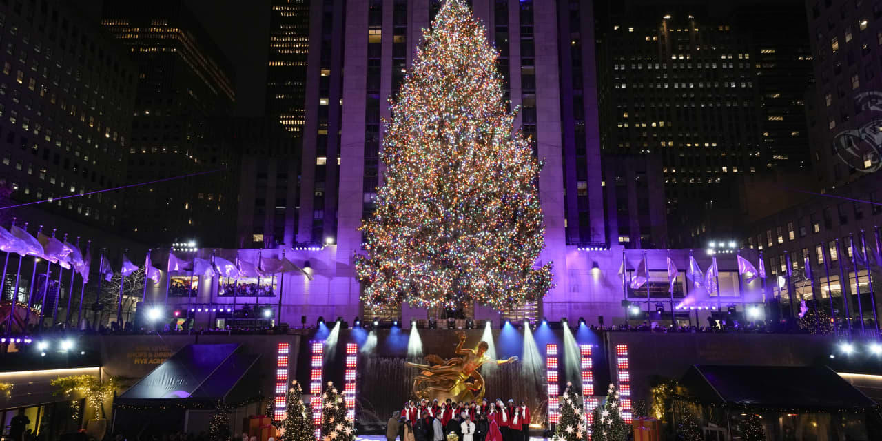 Iconic Christmas tree at Rockefeller Center illuminated amid nearby protest