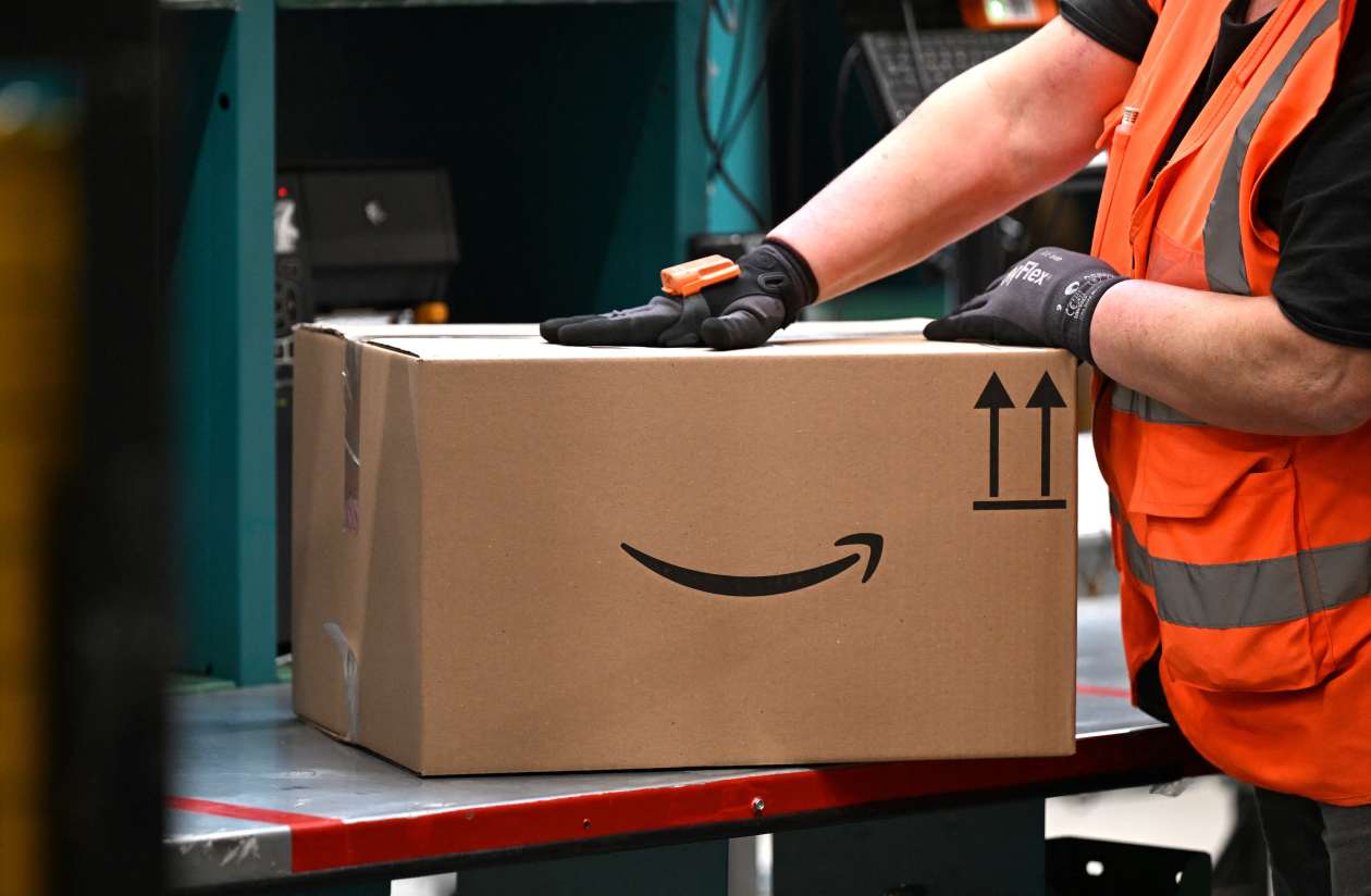 Amazon box being handled in a warehouse.