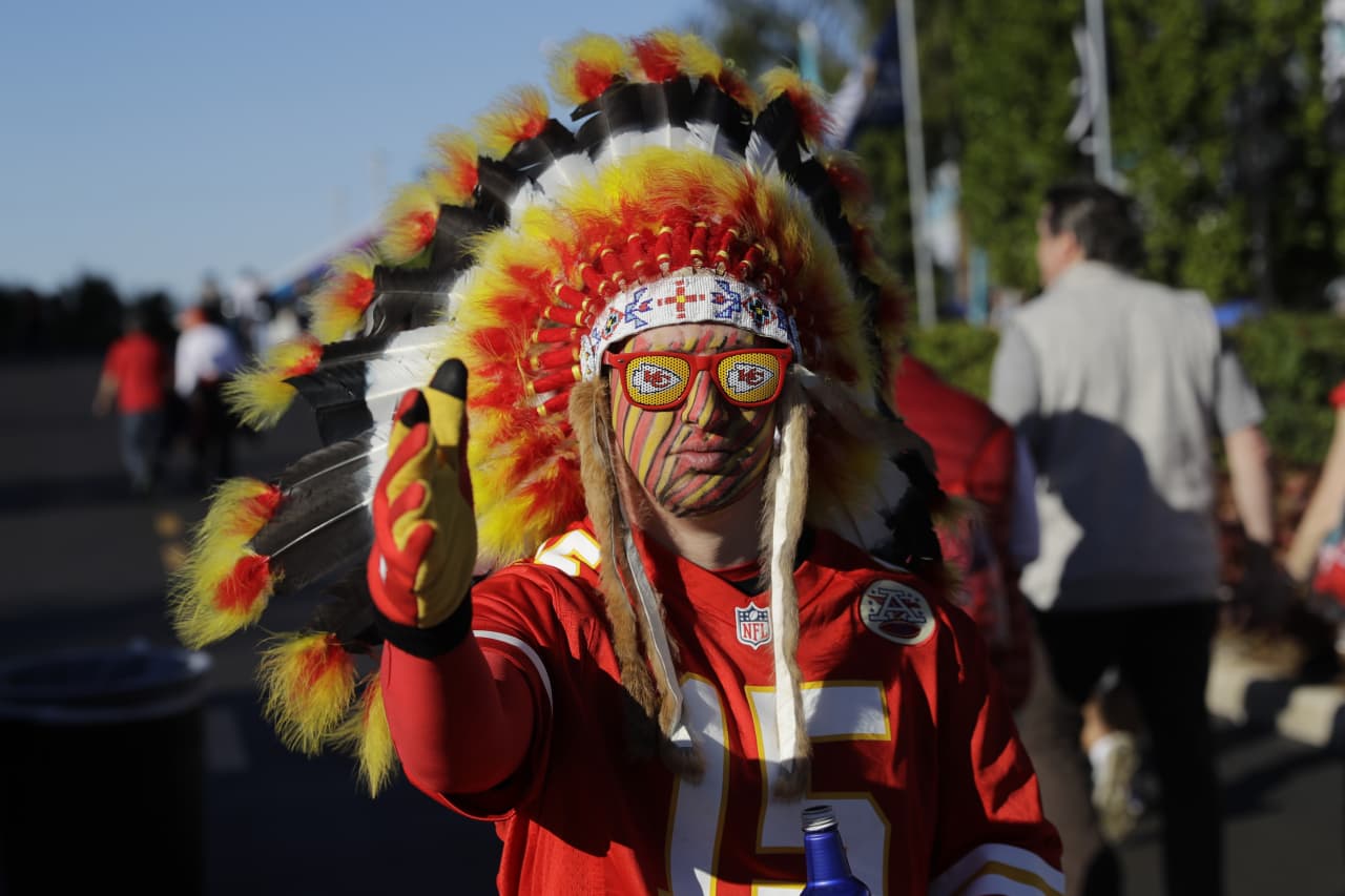 Kansas City Chiefs fans wear rain gear before an NFL football game