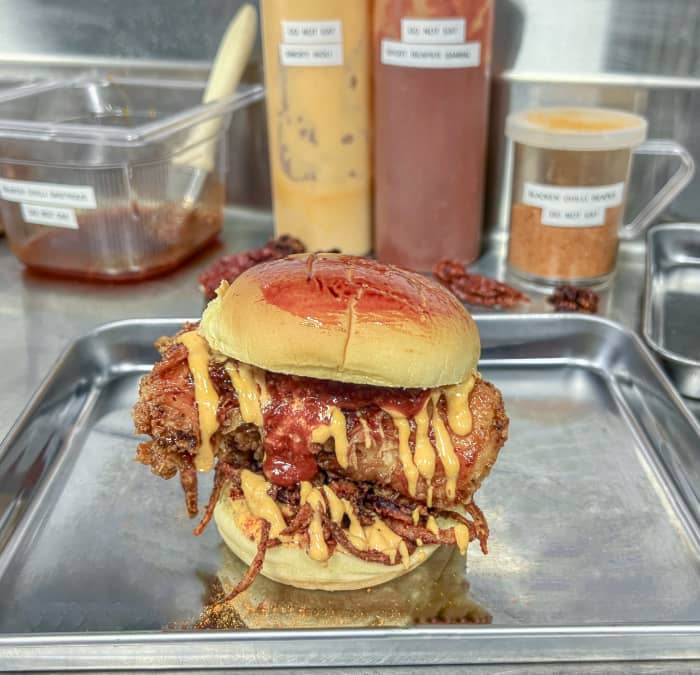 A man signs a waiver before eating a medium-cooked burger at a Toronto hotel.