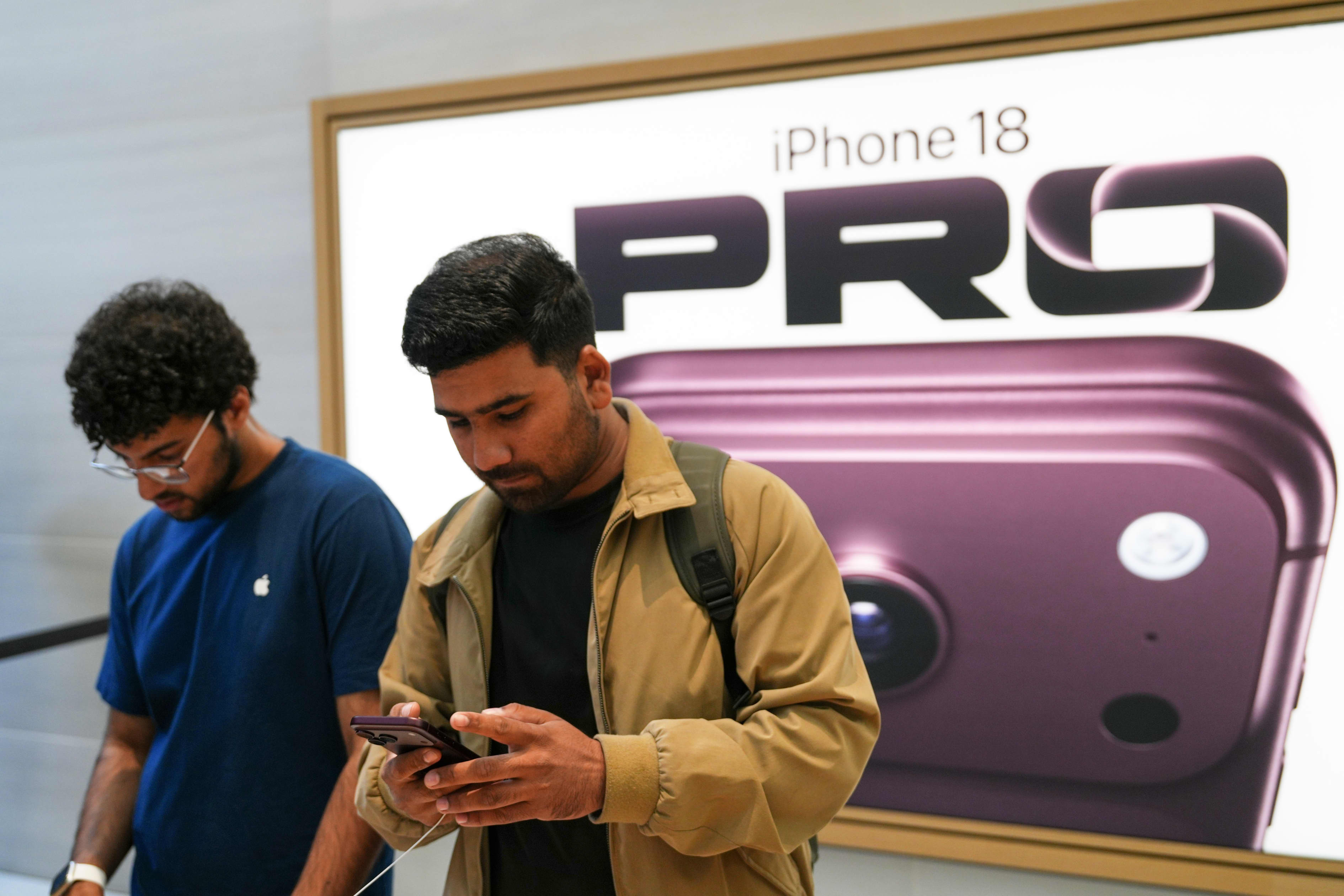 A person interacts with an iPhone 18 Pro at Apple Regent Street in London.