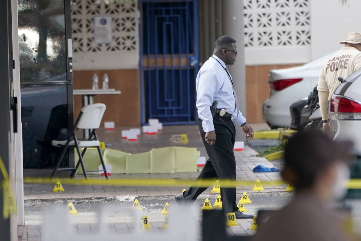 Law enforcement officials work the scene of a shooting outside a banquet hall near Hialeah, Fla., on Sunday. ASSOCIATED PRESS