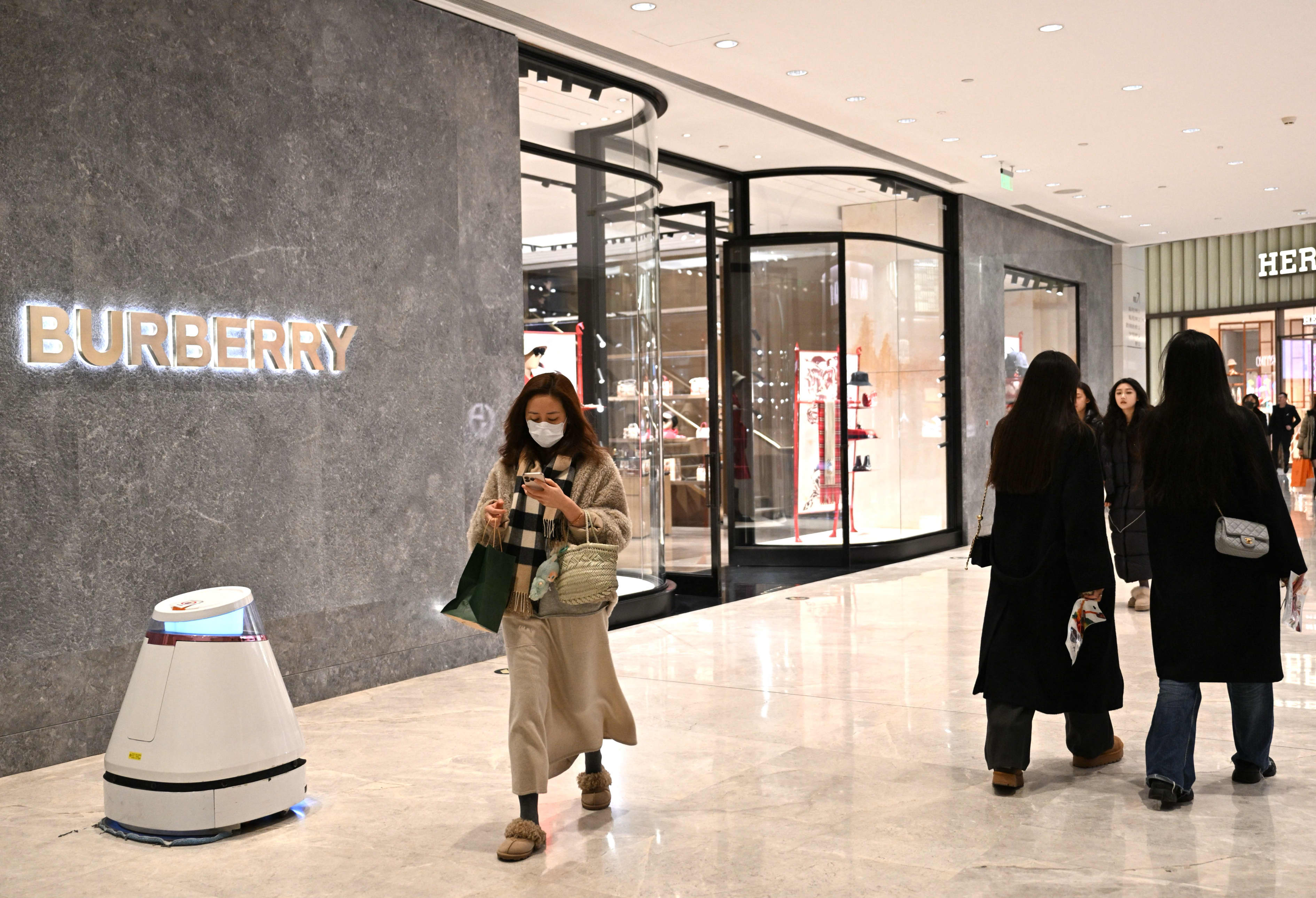 People traversing a walkway at a mall in Beijing in January did not appear overburdened by shopping parcels.