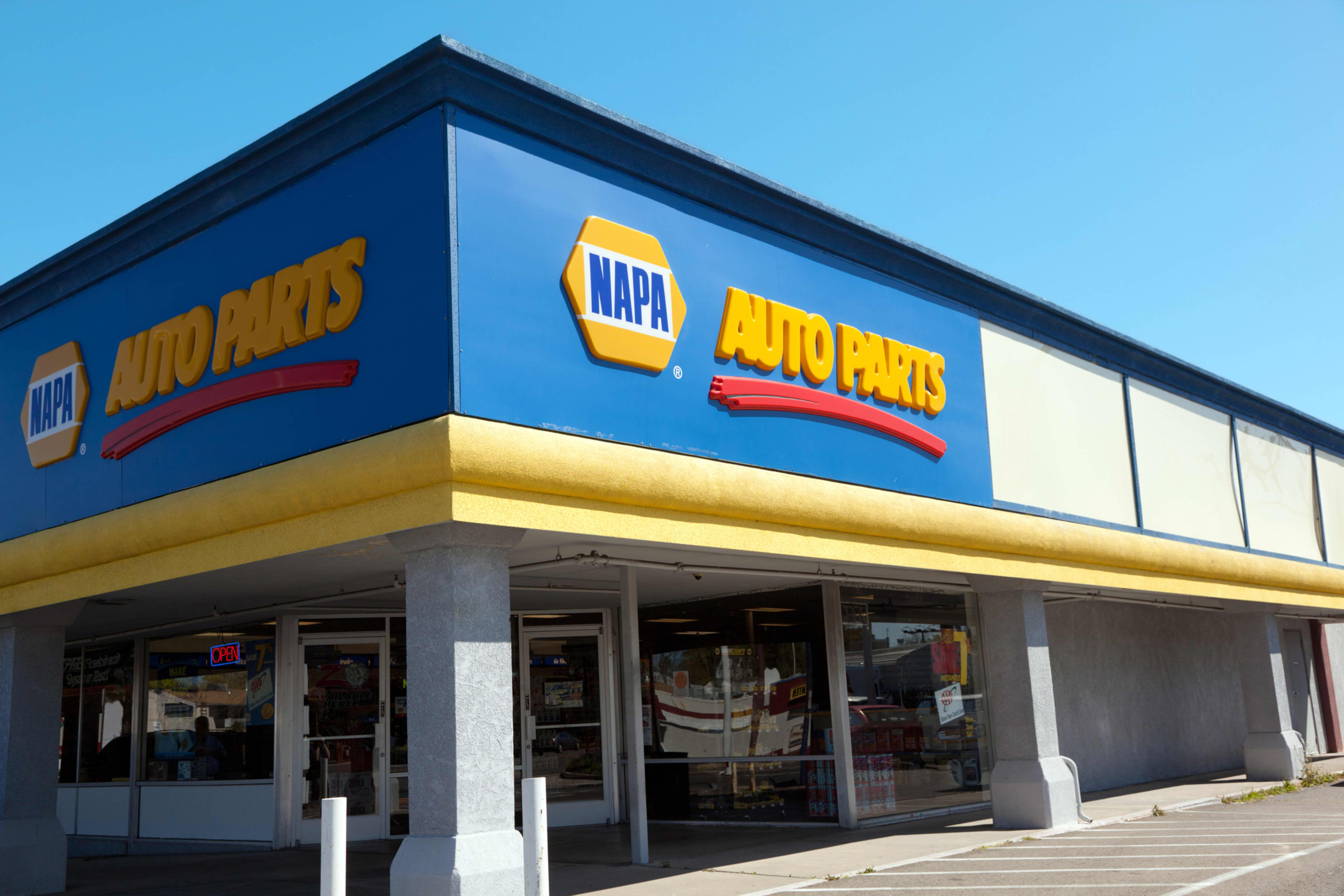 The exterior of a NAPA Auto Parts store with a blue and yellow sign.