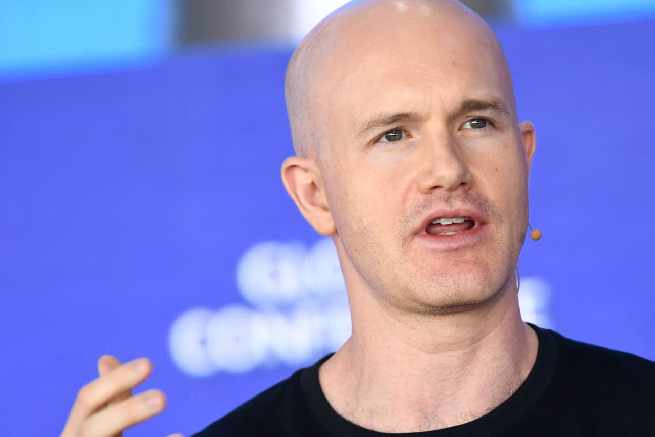 Coinbase will lay off 14% of its staff as AI spurs ‘a new way of working’