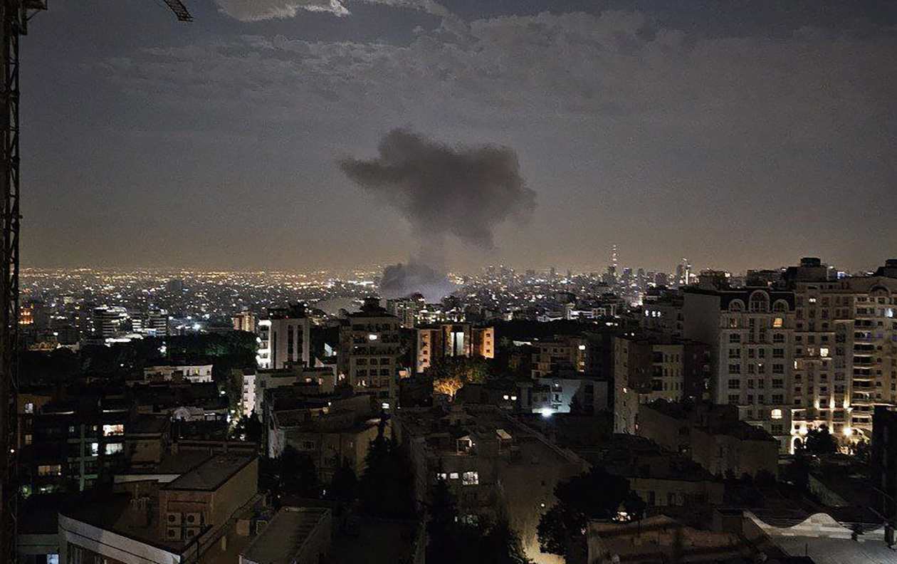 Smoke billowing over Tehran at night following an Israeli airstrike.
