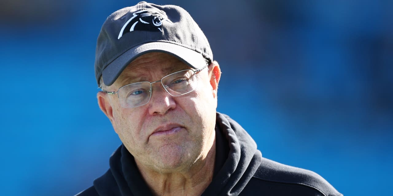 The video appears to show Panthers owner David Tepper throwing a drink at an opposing fan.