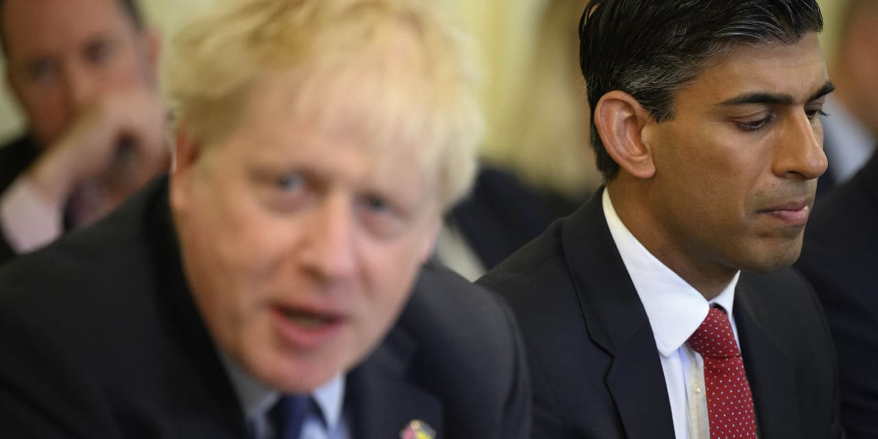 Boris Johnson clings to power after two senior Cabinet members quit