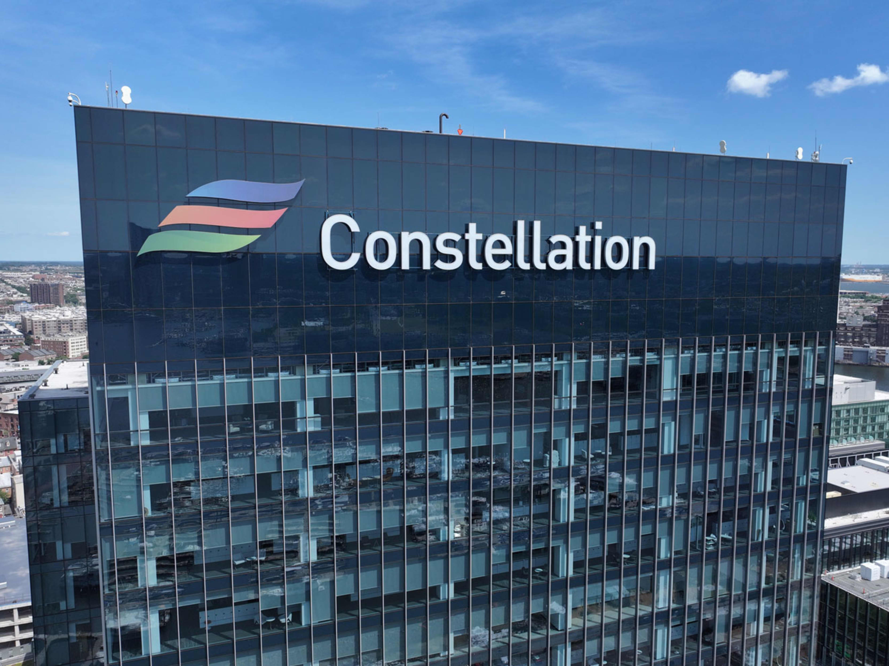 Constellation logo and name on a tall glass building.