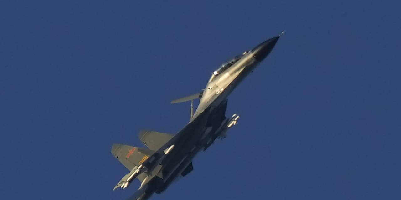 China flexes military strength near Taiwan, flying dozens of warplanes