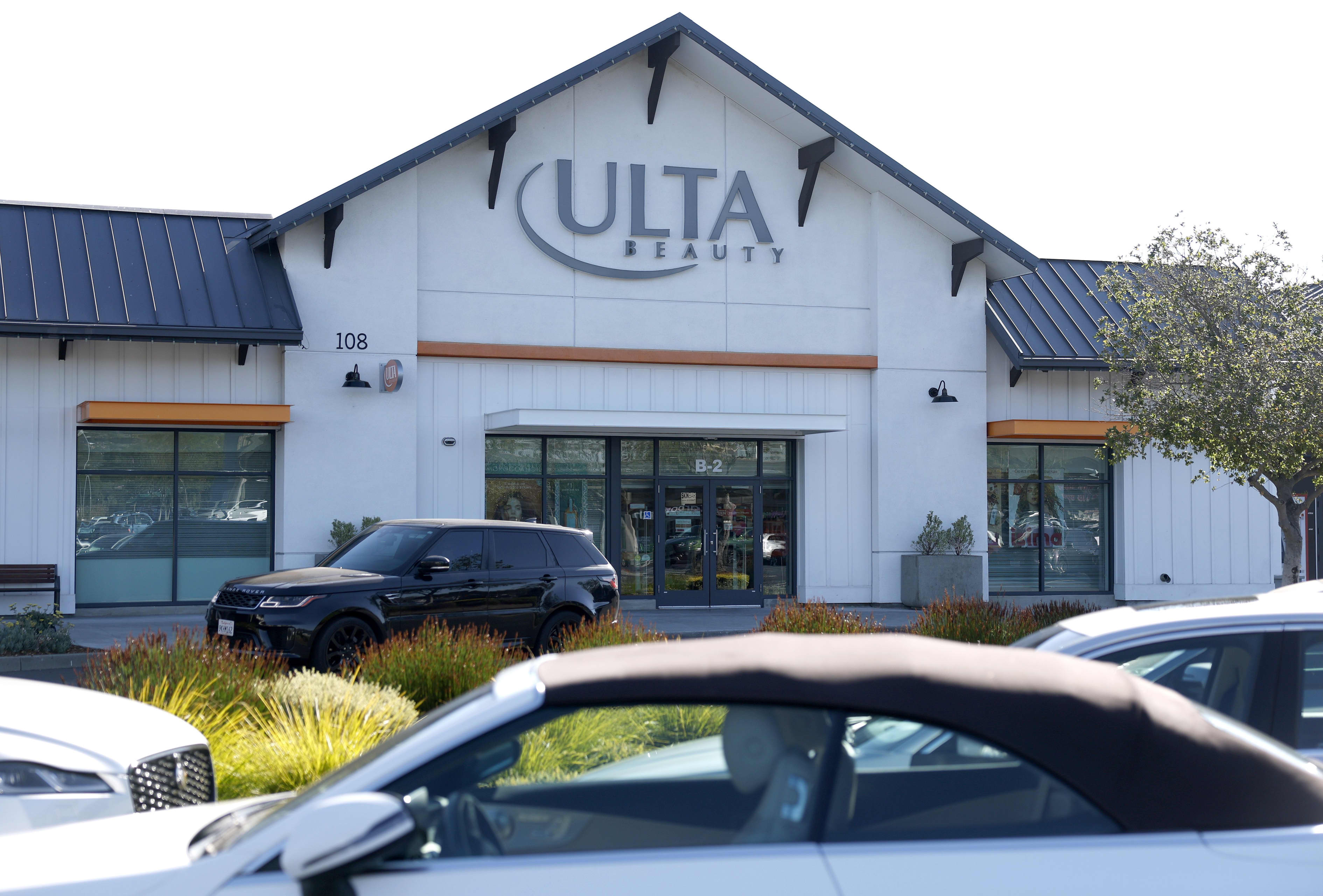 The exterior of an Ulta Beauty store with cars parked in front.