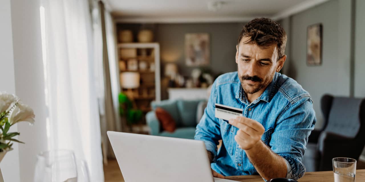 I want to pay off $20,000 of credit-card debt in one year. Should I hire someone to negotiate my bill?