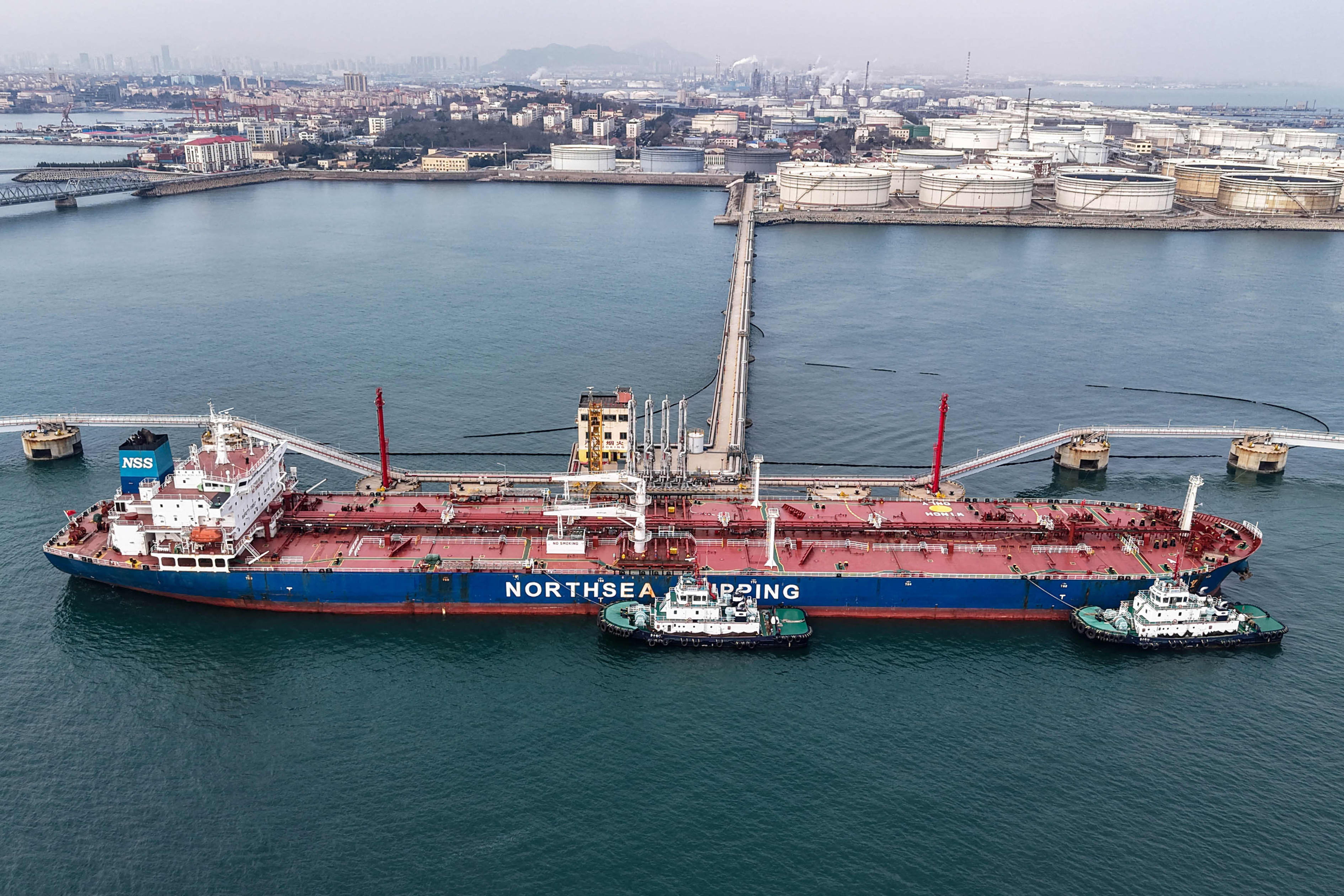 Oil tanker unloading crude oil at a terminal in Qingdao, China.