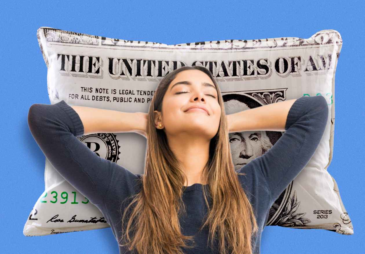 Woman relaxing with head on a dollar bill pillow.