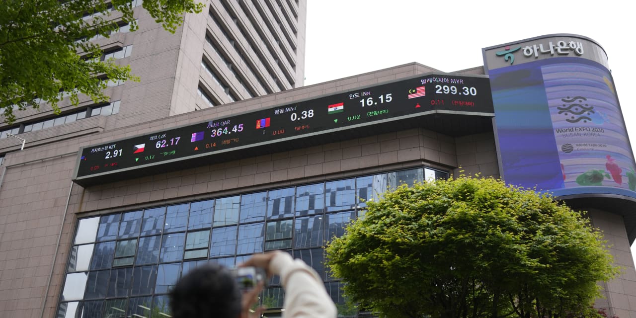 Asian markets trading mostly lower as inflation worries linger