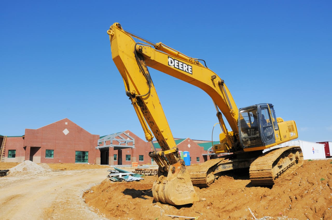 Deere’s stock jumps toward another record. The construction business is booming again.