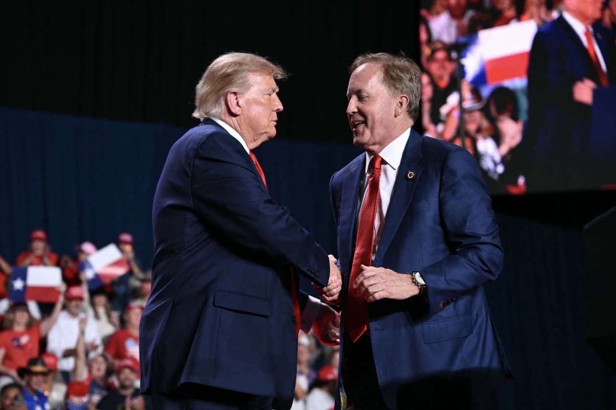 US President Donald Trump shakes hands with Republican candidate for US Senate Ken Paxton.
