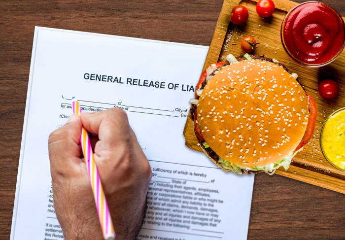 A man signs a waiver before eating a medium-cooked burger at a Toronto hotel.