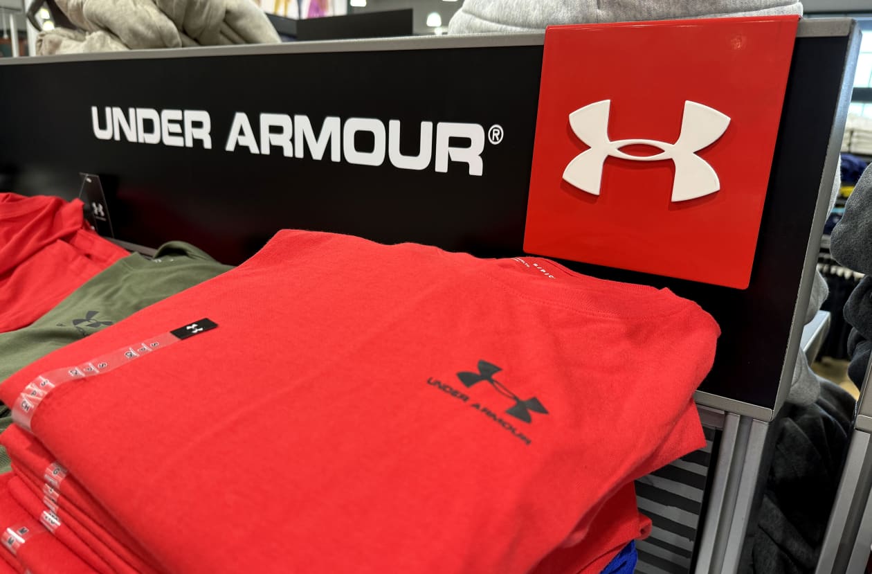 Under Armour logo and red t-shirts on display.